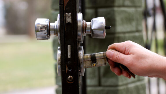 An image of a new lock being fitted to an outside door